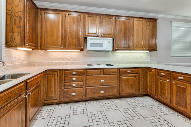 kitchen featuring ornamental molding, tasteful backsplash, sink, and white appliances