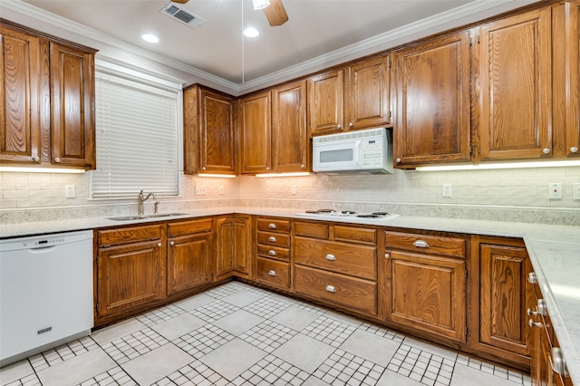 kitchen with tasteful backsplash, ceiling fan, crown molding, sink, and white appliances