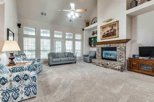 living room with a brick fireplace, carpet floors, high vaulted ceiling, and ceiling fan