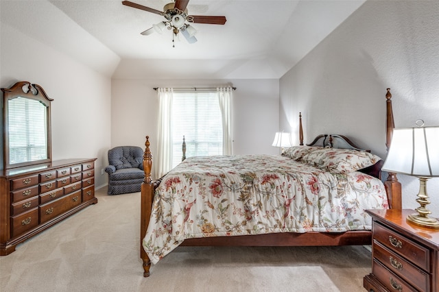 carpeted bedroom with ceiling fan and lofted ceiling