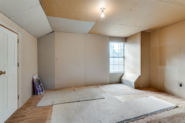 empty room featuring lofted ceiling