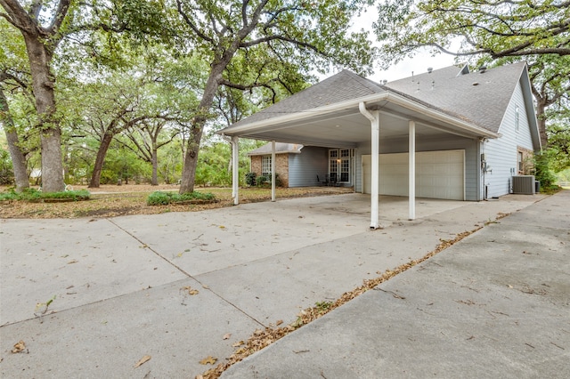 exterior space with a garage and a carport