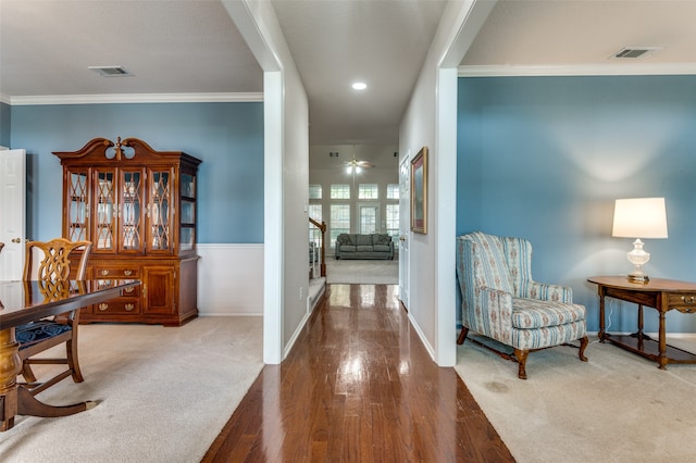 hallway with hardwood / wood-style flooring and ornamental molding