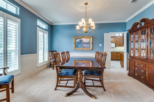 carpeted dining room featuring crown molding and a notable chandelier