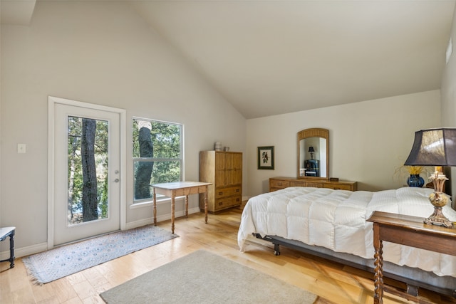 bedroom featuring high vaulted ceiling, access to outside, and light wood-type flooring