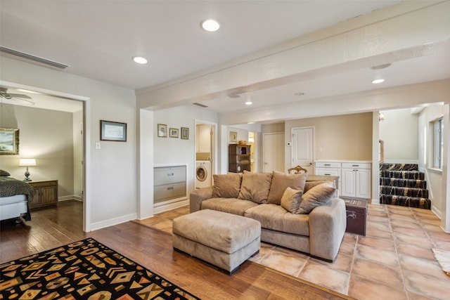 living room with washer / clothes dryer and light hardwood / wood-style floors