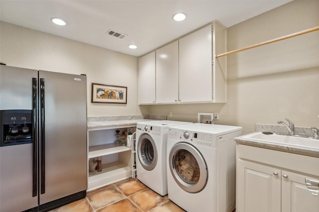 laundry room featuring cabinets, washer and dryer, and sink