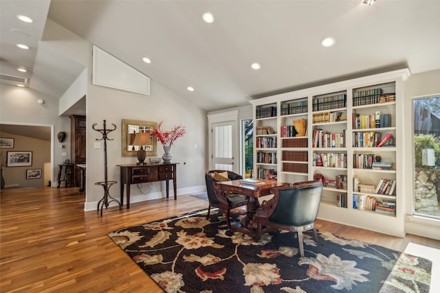 living area featuring hardwood / wood-style flooring and lofted ceiling