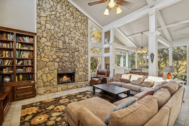 living room featuring ceiling fan with notable chandelier, high vaulted ceiling, decorative columns, a stone fireplace, and beamed ceiling