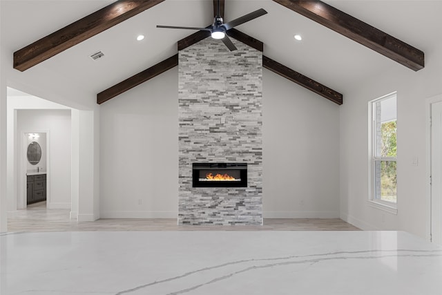 unfurnished living room featuring high vaulted ceiling, a tile fireplace, ceiling fan, beamed ceiling, and light hardwood / wood-style floors