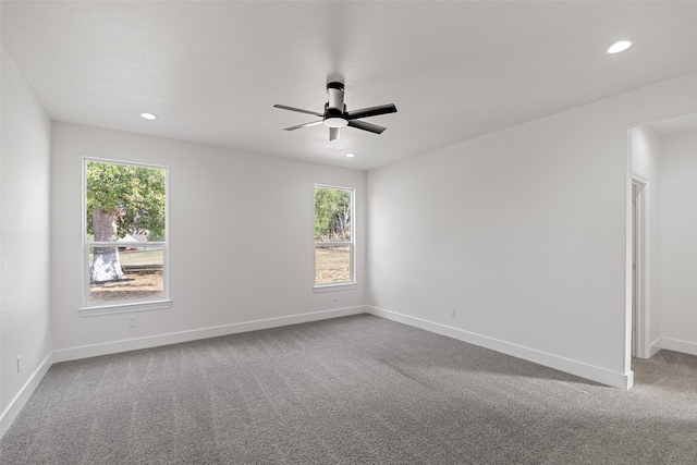 carpeted spare room with ceiling fan