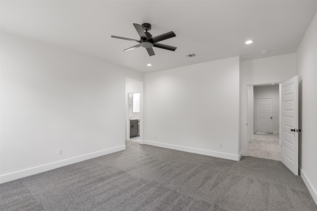 spare room with ceiling fan and carpet