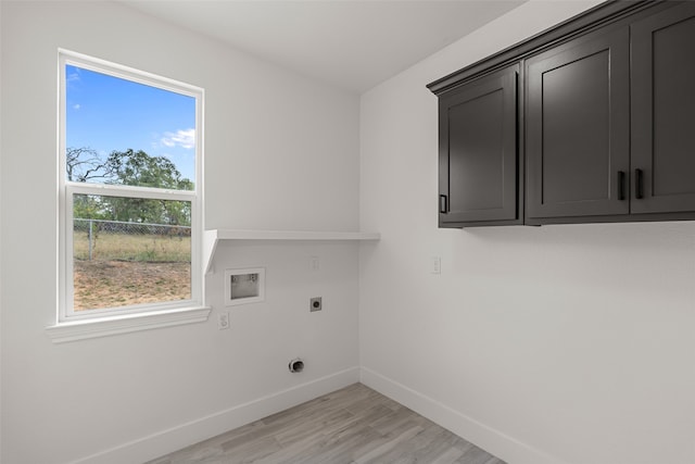 washroom featuring cabinets, hookup for a washing machine, light hardwood / wood-style flooring, and electric dryer hookup