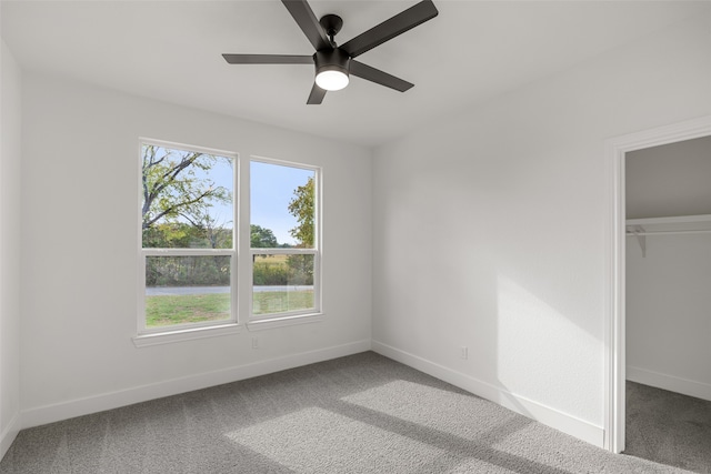 unfurnished bedroom featuring carpet, ceiling fan, and a closet