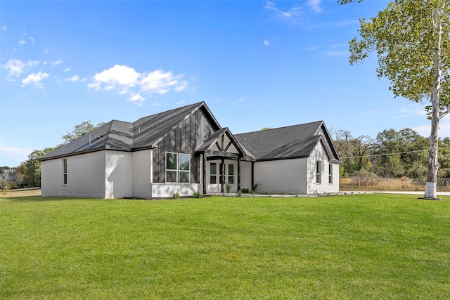 rear view of property with a lawn