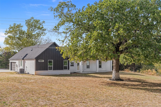 back of house with a yard and cooling unit