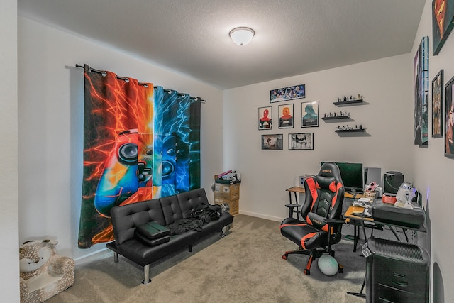 carpeted home office featuring a textured ceiling