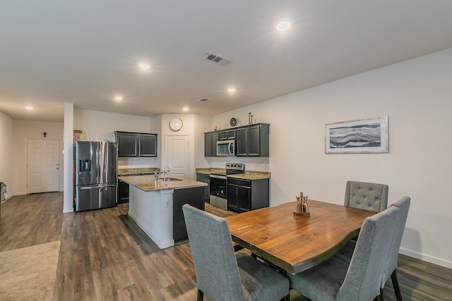 dining space featuring sink and dark hardwood / wood-style floors