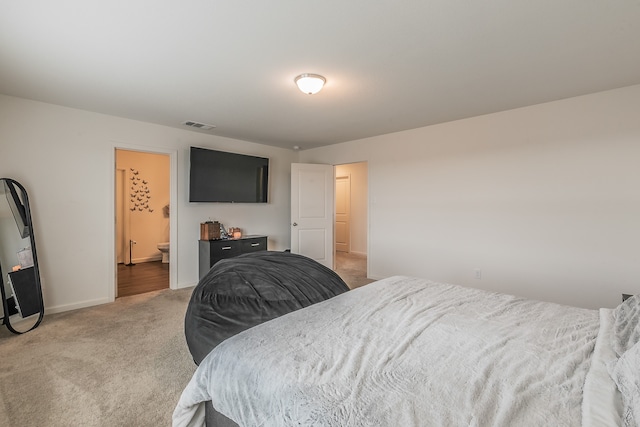 carpeted bedroom featuring ensuite bathroom