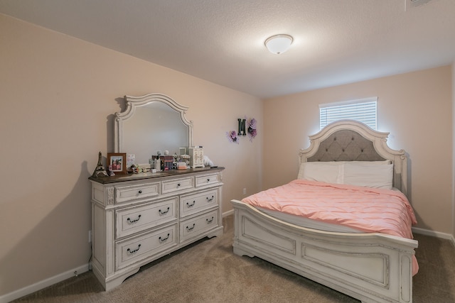 carpeted bedroom with a textured ceiling