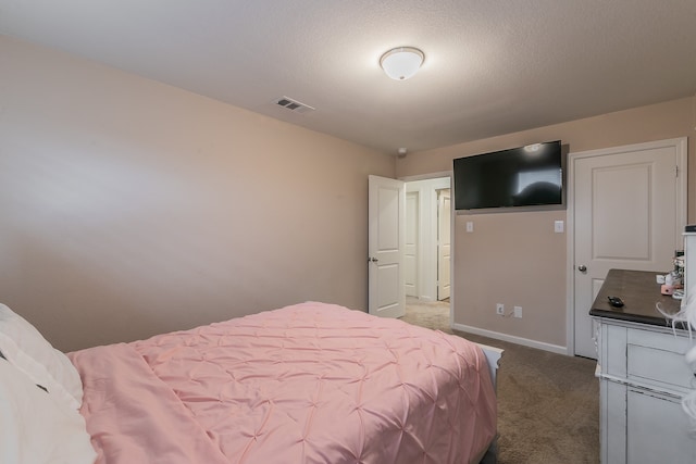 bedroom featuring a textured ceiling and carpet flooring