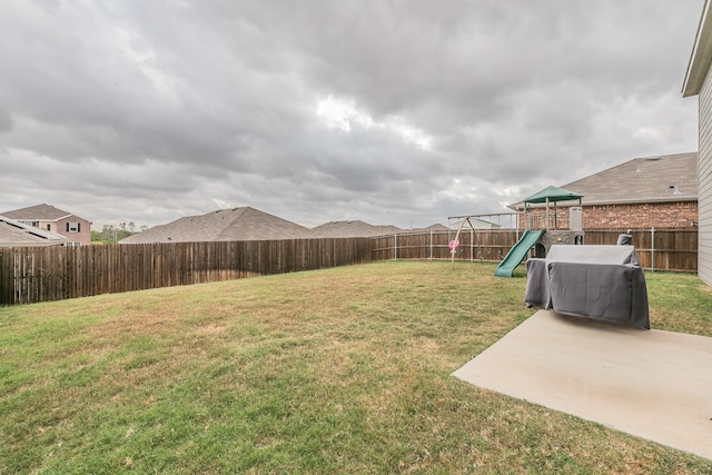 view of yard featuring a patio area and a playground