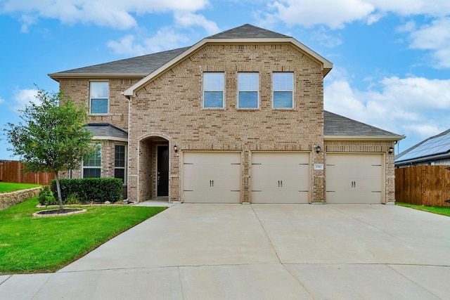 view of front of house with a front yard and a garage