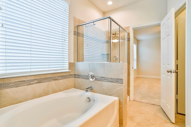 bathroom with plus walk in shower and tile patterned flooring