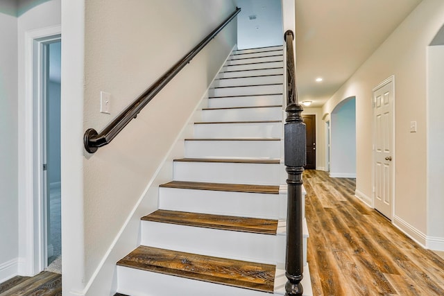 stairway with hardwood / wood-style floors