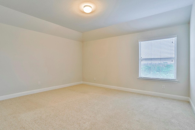 spare room featuring light colored carpet