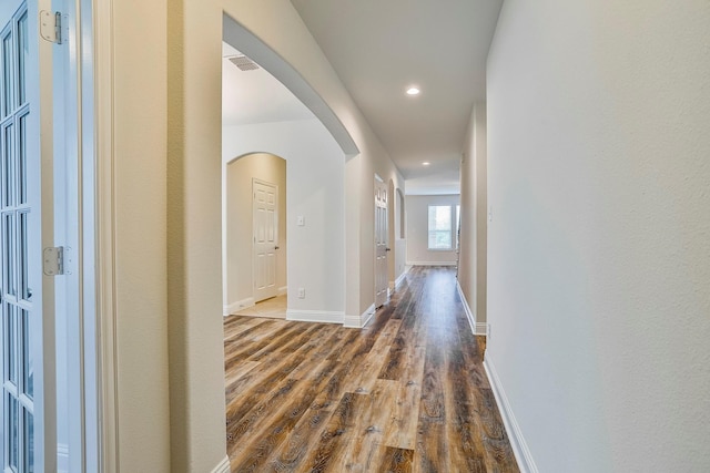 hallway with dark hardwood / wood-style flooring