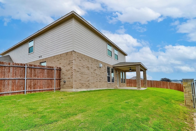 back of property with a yard and a patio area