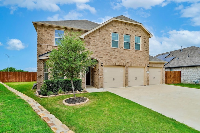 view of front of property with a front yard and a garage