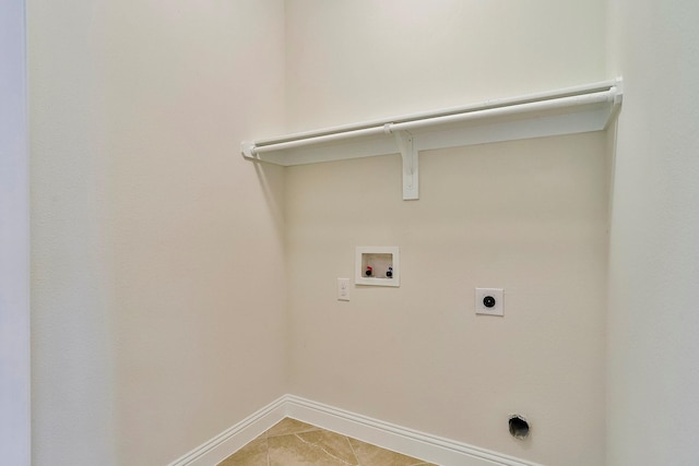 laundry room with hookup for a washing machine, electric dryer hookup, and light tile patterned floors