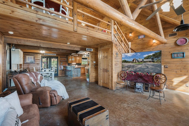 living room with wood ceiling, ceiling fan, high vaulted ceiling, french doors, and wood walls