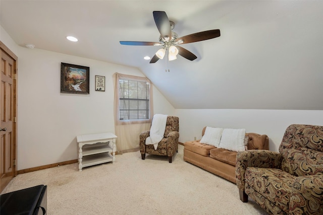 living area featuring ceiling fan, carpet floors, and vaulted ceiling