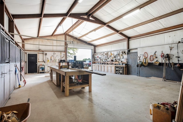 garage featuring a workshop area and metal wall