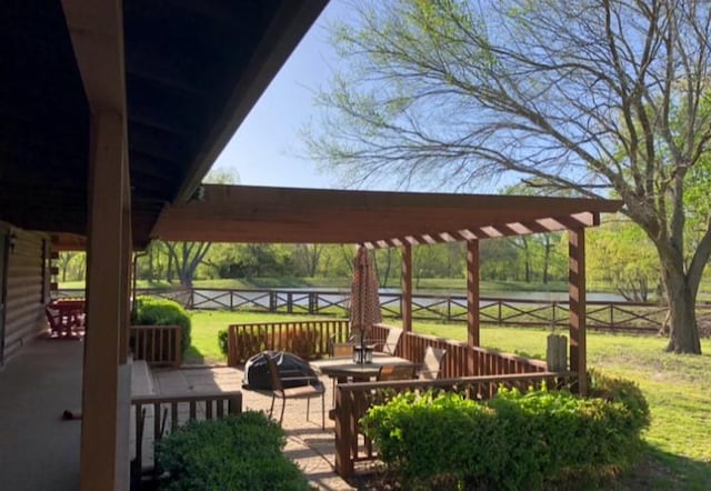 view of community featuring a wooden deck and a yard