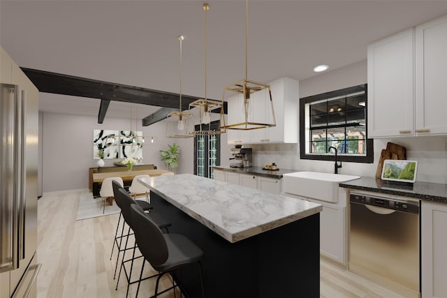 kitchen featuring light stone counters, a sink, a center island, and stainless steel dishwasher