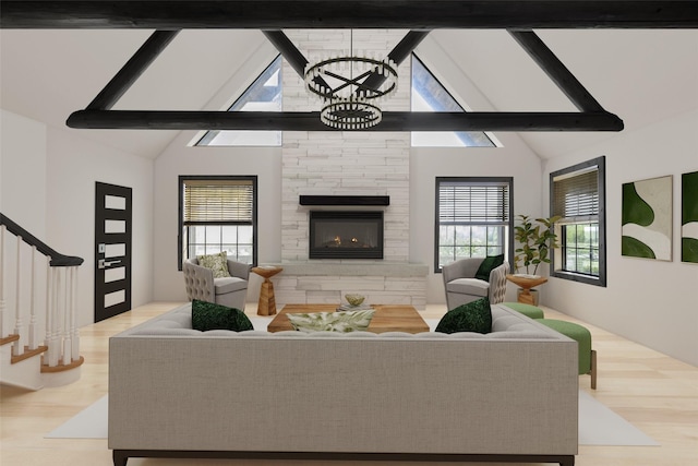 living area with a wealth of natural light, light wood-style flooring, a fireplace, and stairs