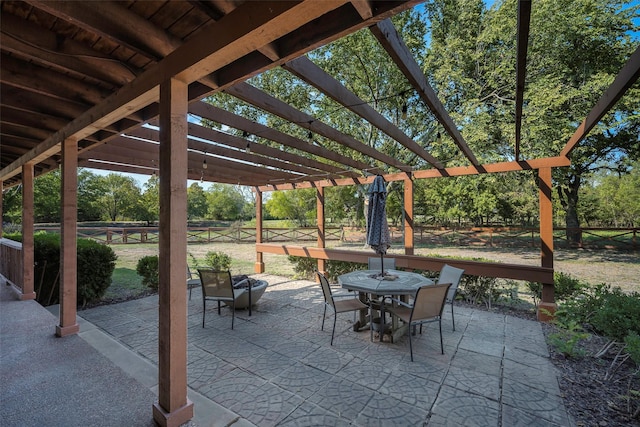 view of patio / terrace featuring outdoor dining space, a pergola, and fence