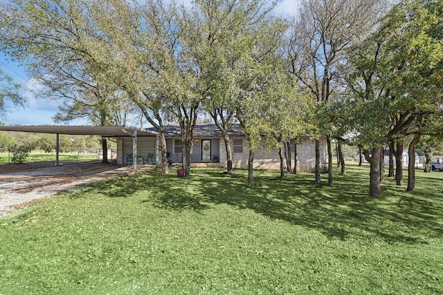 view of front facade with a front yard and a carport