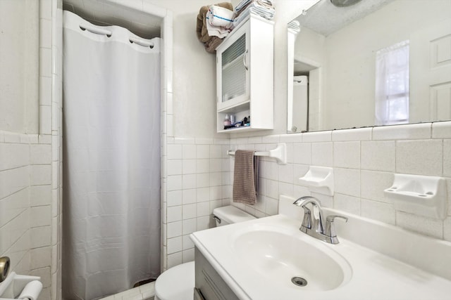 bathroom featuring vanity, toilet, tile walls, and a shower with shower curtain