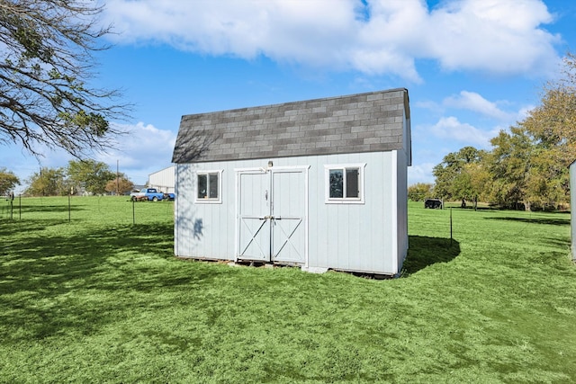 view of outbuilding with a yard