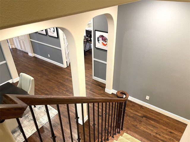 staircase featuring wood-type flooring