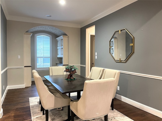 dining area featuring crown molding and dark hardwood / wood-style flooring