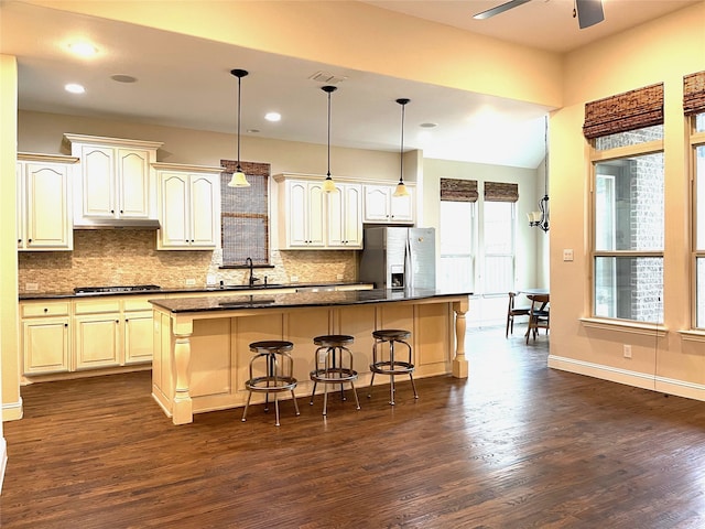 kitchen with dark wood-type flooring, a center island, and stainless steel appliances