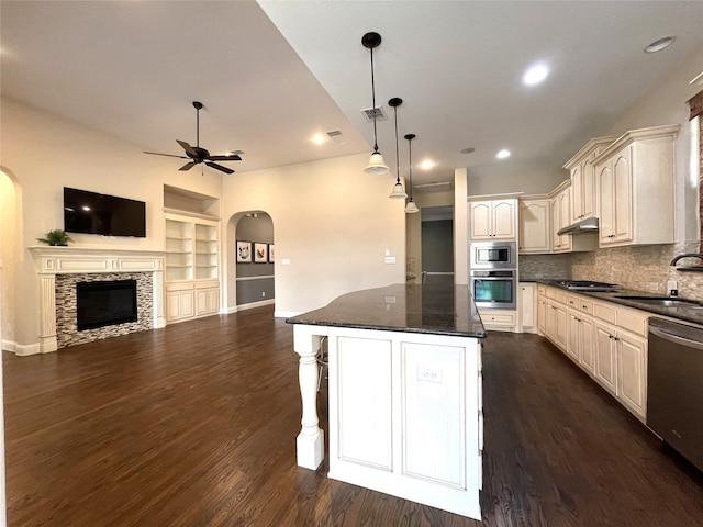 kitchen with appliances with stainless steel finishes, sink, pendant lighting, and dark hardwood / wood-style floors