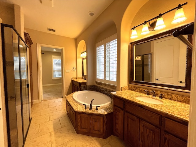 bathroom featuring vanity and separate shower and tub