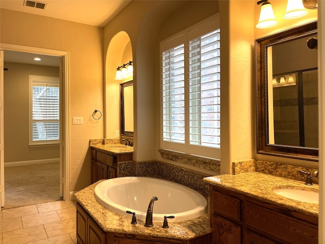 bathroom with vanity, shower with separate bathtub, and tile patterned flooring